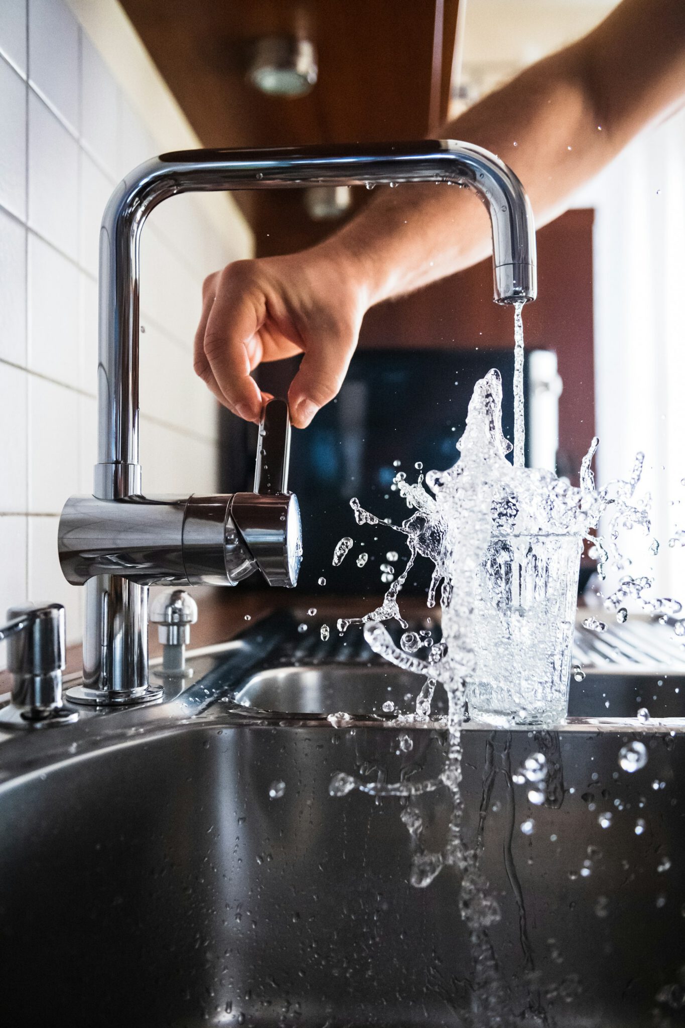 Emergency plumber in Horsell checking a kitchen tap after a repair