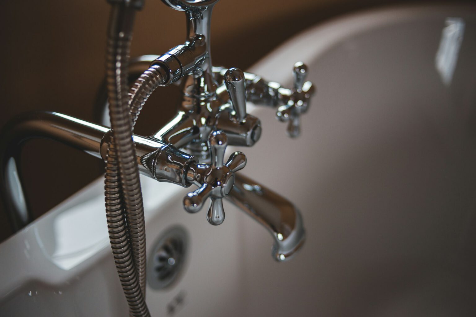 Chrome bath tap and shower pipework repaired by an emergency plumber in Woking