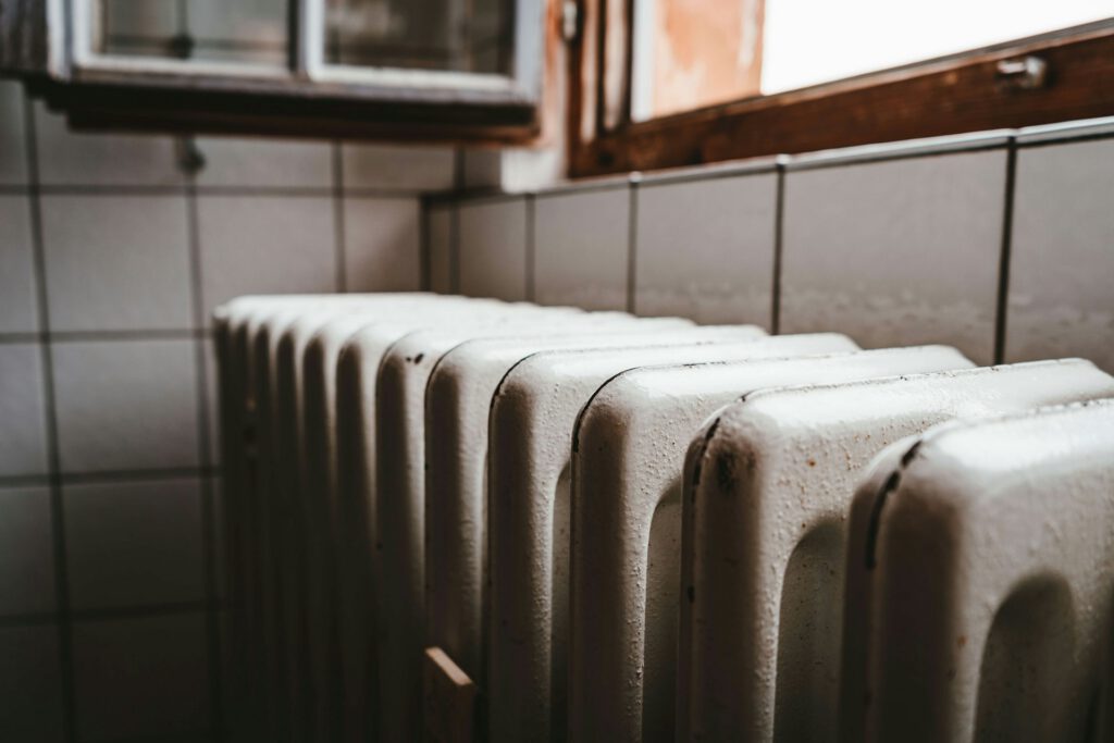 Column radiator on a tiled wall, part of a central heating system